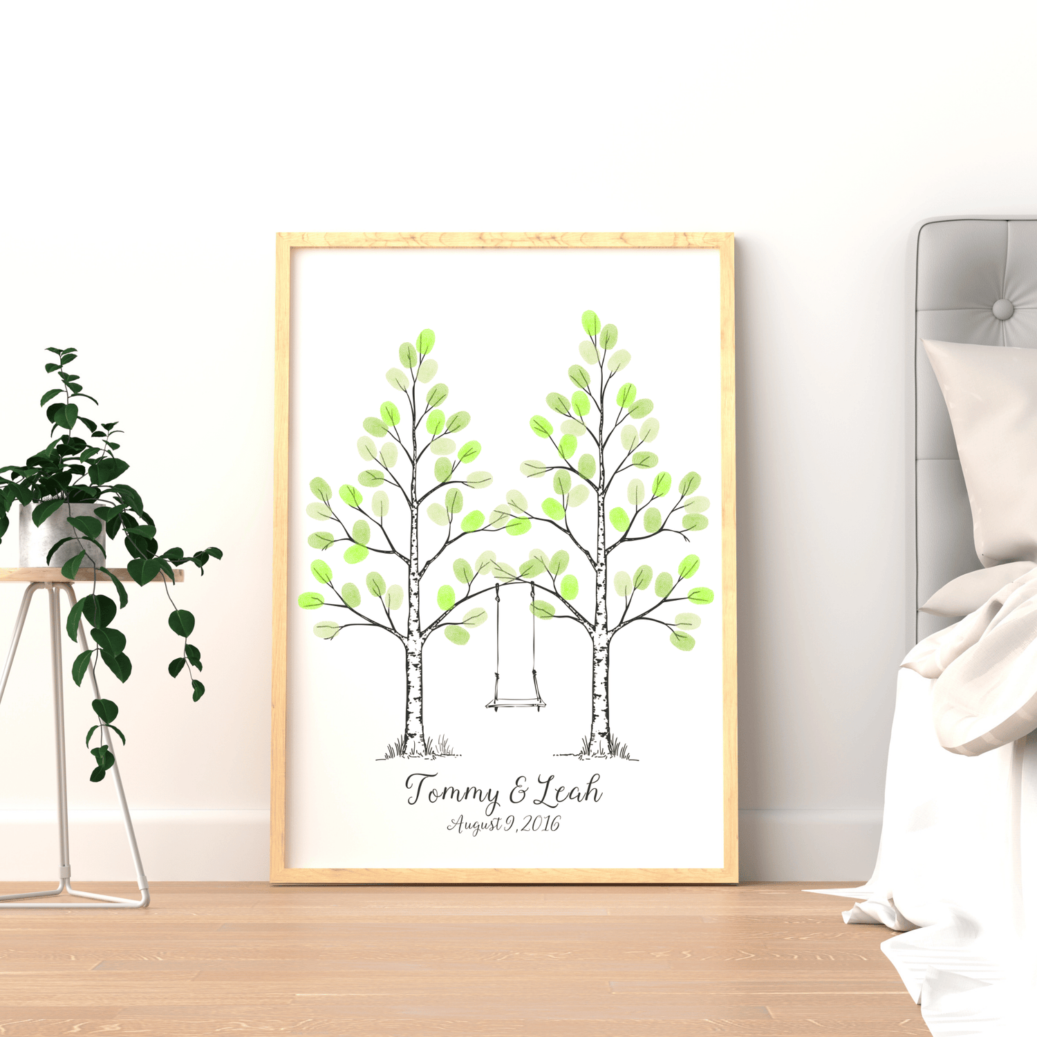 Framed fingerprint tree wedding guest book displayed on wall as romantic keepsake.