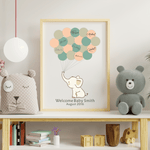 Personalized elephant baby shower guest book in a white frame, featuring multicolored balloon prints and styled on a modern nursery shelf.