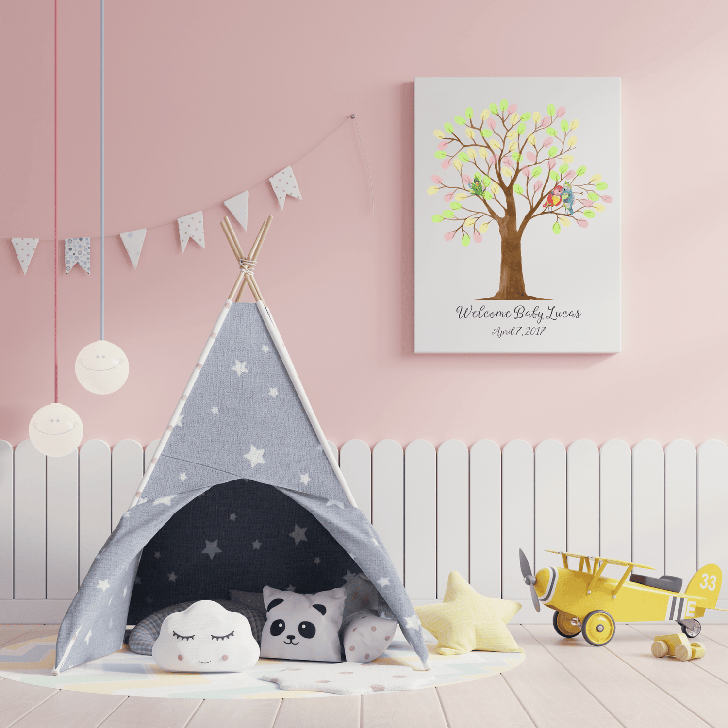 Cozy nursery featuring a gray teepee, plush toys, and a colorful baby shower fingerprint tree art.