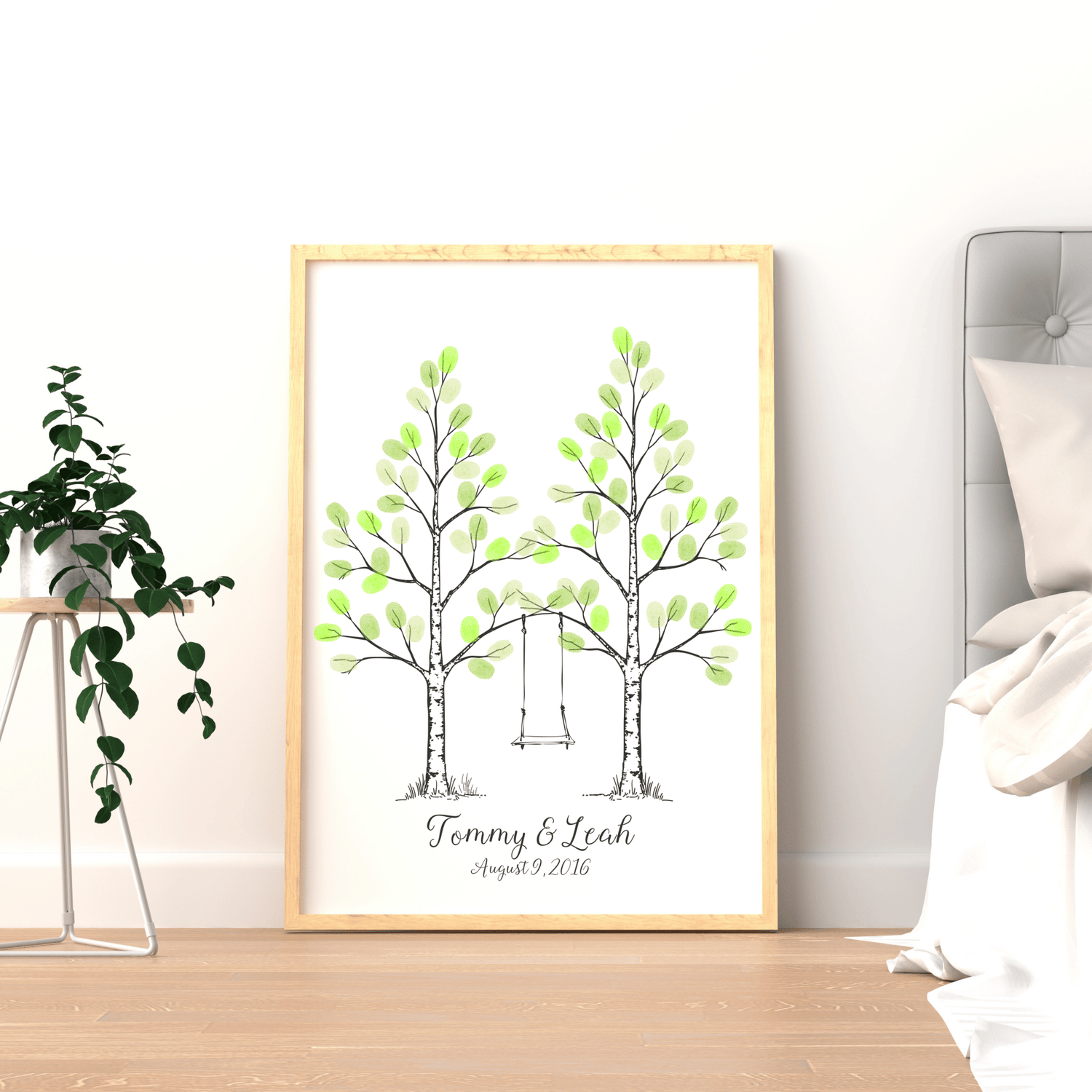 Framed fingerprint tree wedding guest book displayed on wall as romantic keepsake.