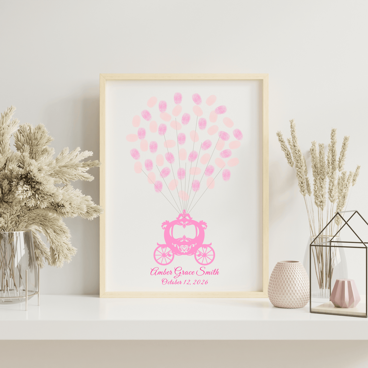 Whimsical baby shower guest book with fingerprint balloons in a white frame, styled on a shelf in a princess-themed baby room.
