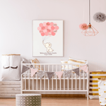 Framed pink elephant baby shower guest book with signature balloons, displayed on a nursery wall above a crib with matching pink decor.