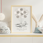 Framed airplane signature balloon guest book on a table 