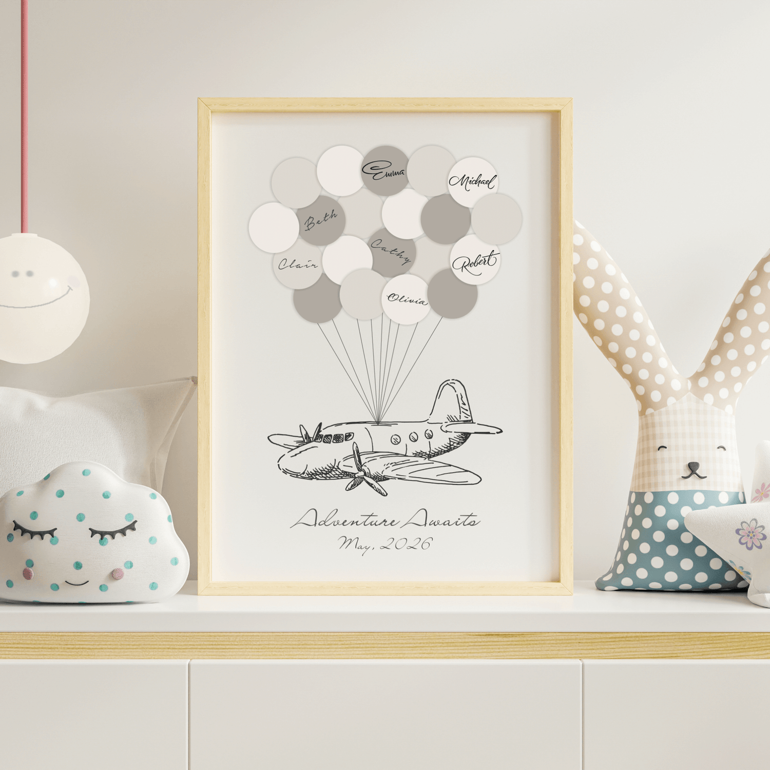 Framed airplane signature balloon guest book on a table 