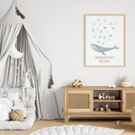 Whale baby shower fingerprint guest book with pale blue thumbprints displayed on a nursery wall