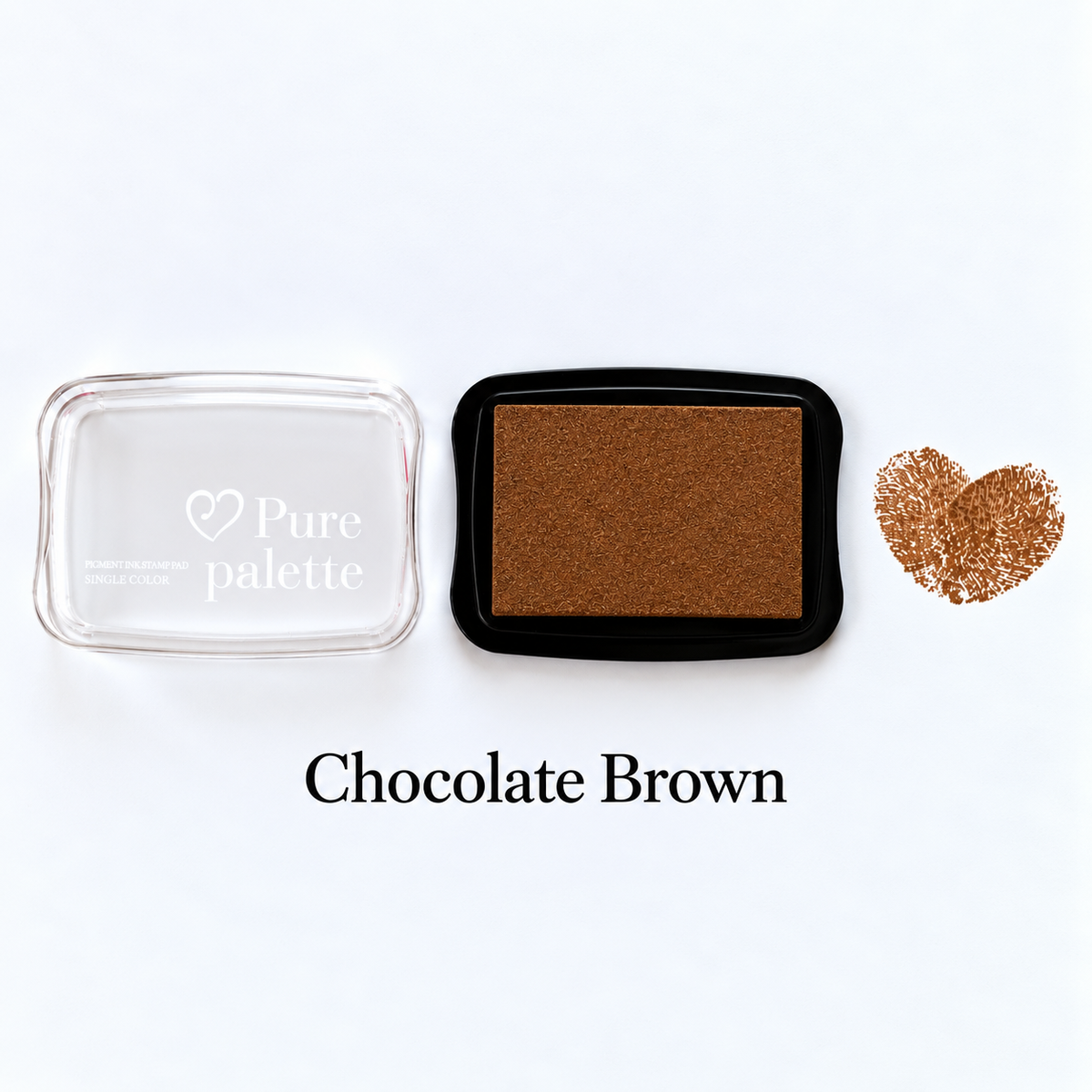 Chocolate brown fingerprint guest book ink pad beside a heart-shaped sample print