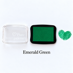 Emerald green fingerprint guest book ink pad beside a heart-shaped sample print