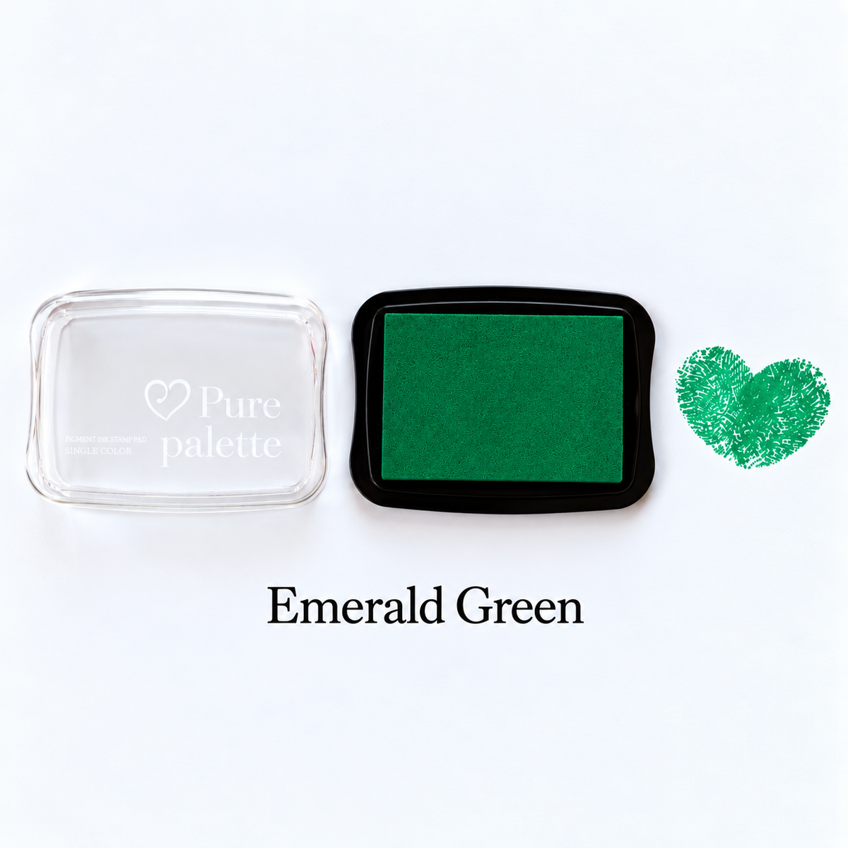 Emerald green fingerprint guest book ink pad beside a heart-shaped sample print