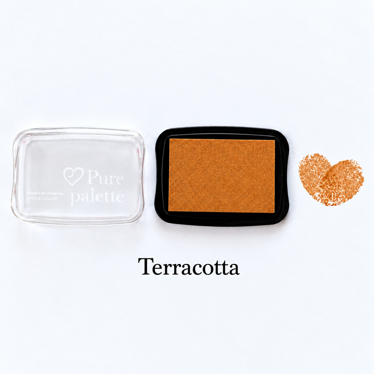 Terracotta fingerprint guest book ink pad beside a heart-shaped sample print