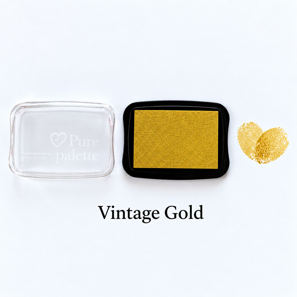 Vintage gold fingerprint guest book ink pad beside a heart-shaped sample print