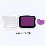 Violet purple fingerprint guest book ink pad beside a heart-shaped sample print