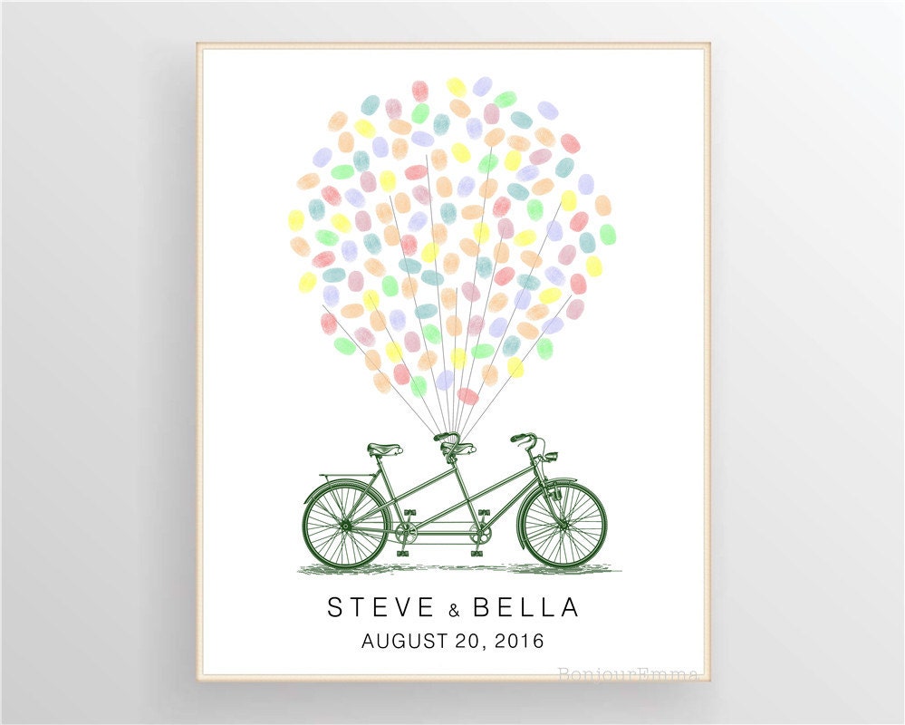 Framed tandem bicycle fingerprint guest book displayed on wall, personalized wedding gift keepsake.