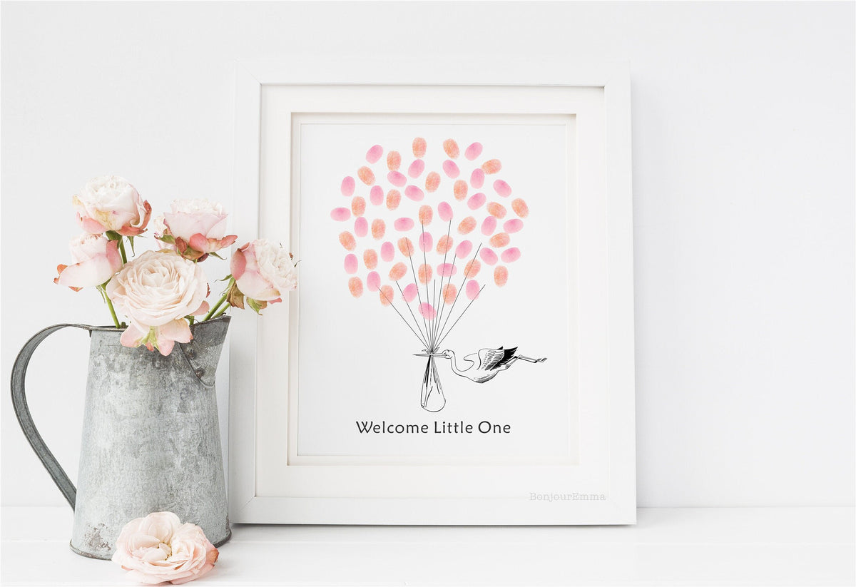 Unique baby shower guest book showing thumbprint balloons held by a stork