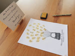 Demo showing guests adding fingerprints to a hot air balloon wedding guest book