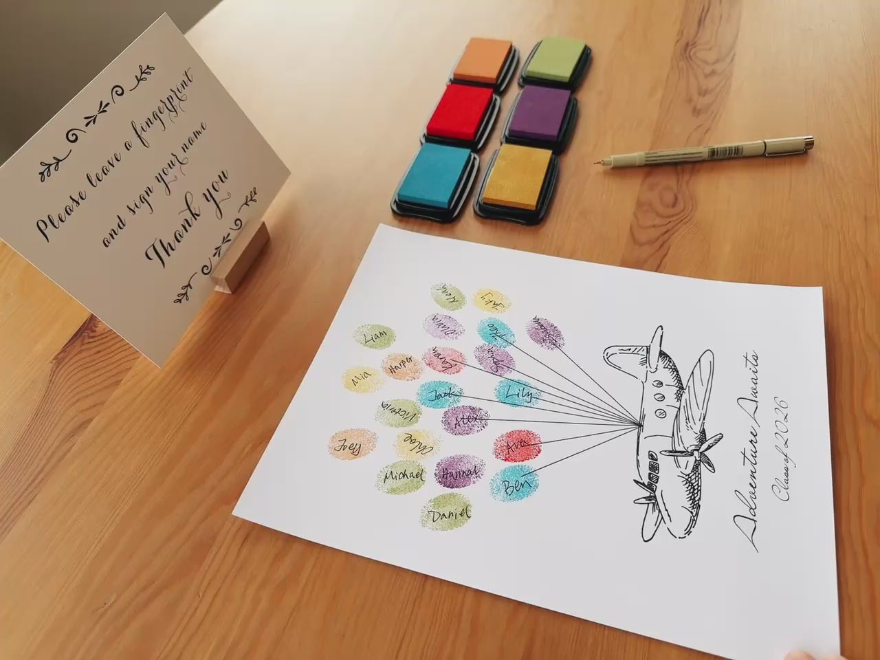 Demo showing fingerprint ink pads being used for guest book keepsake art