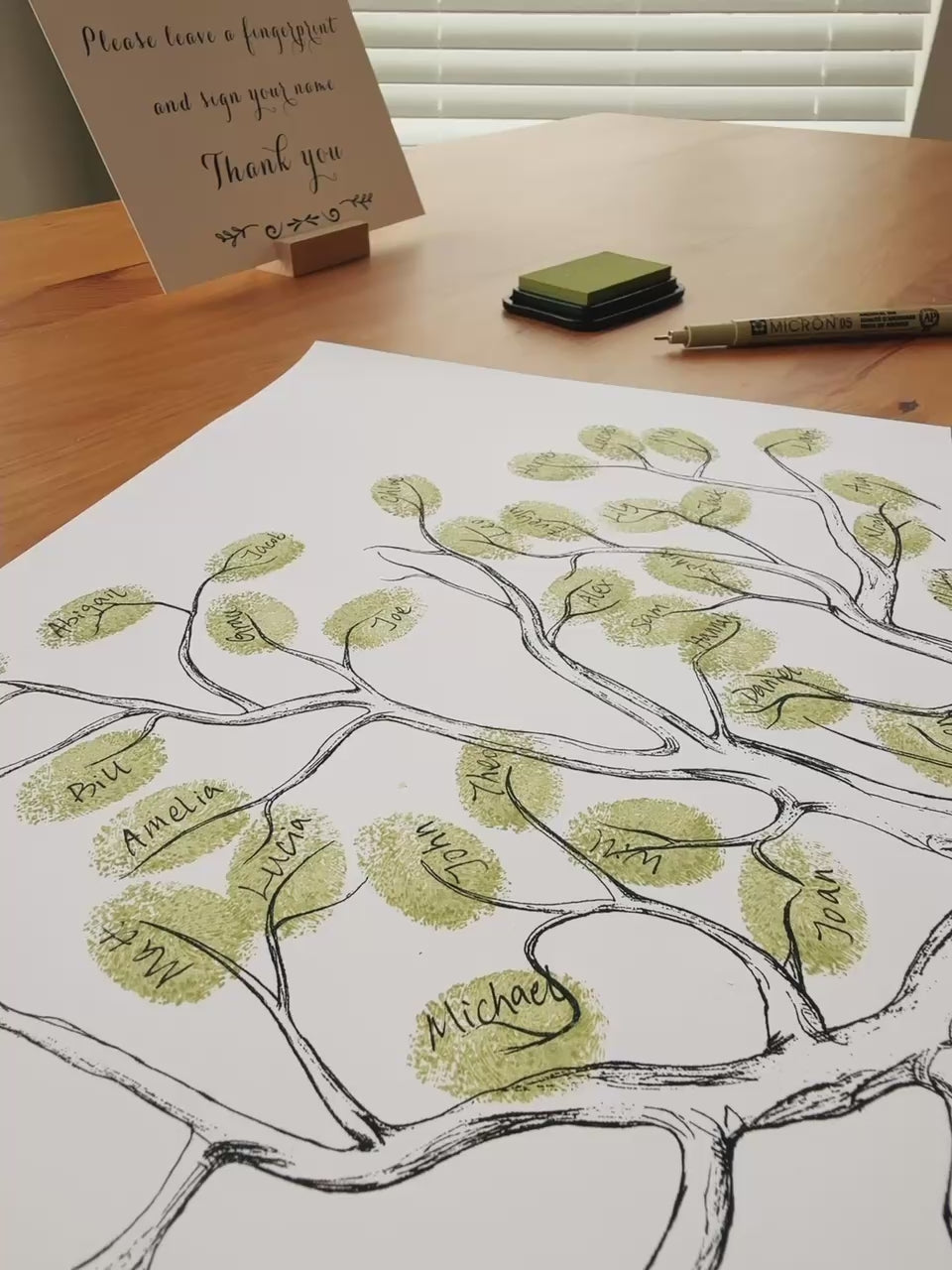 Demo showing guests adding fingerprints to a wedding fingerprint tree guest book